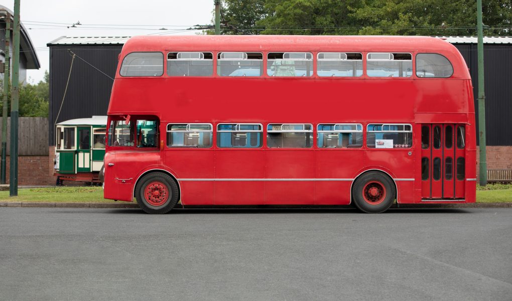 Bus anglais rouge à impériale d'époque pour transporter les invités d'un mariage